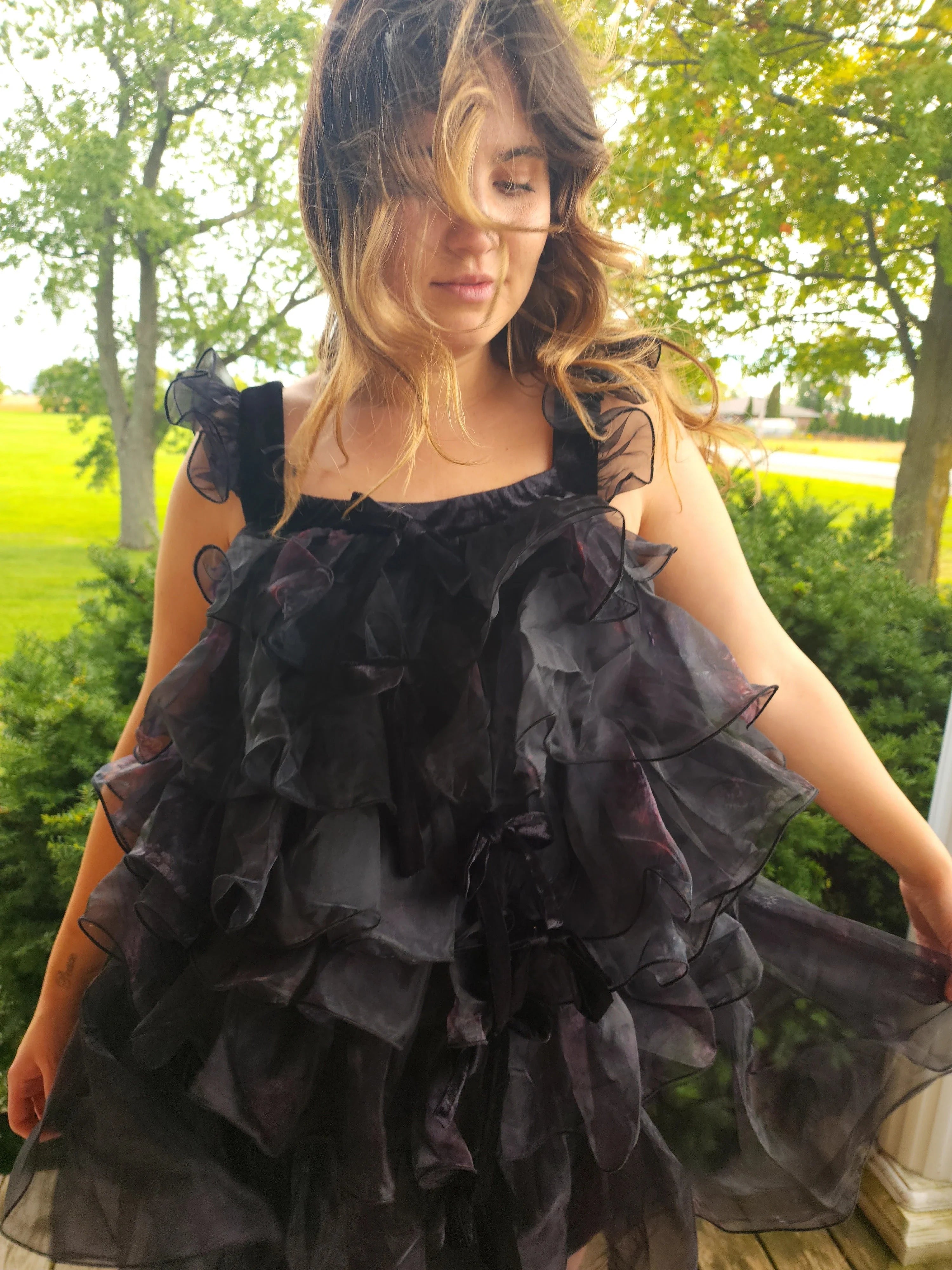 Ruffled black Feather Mini Dress featuring layered fabric details and a chic design