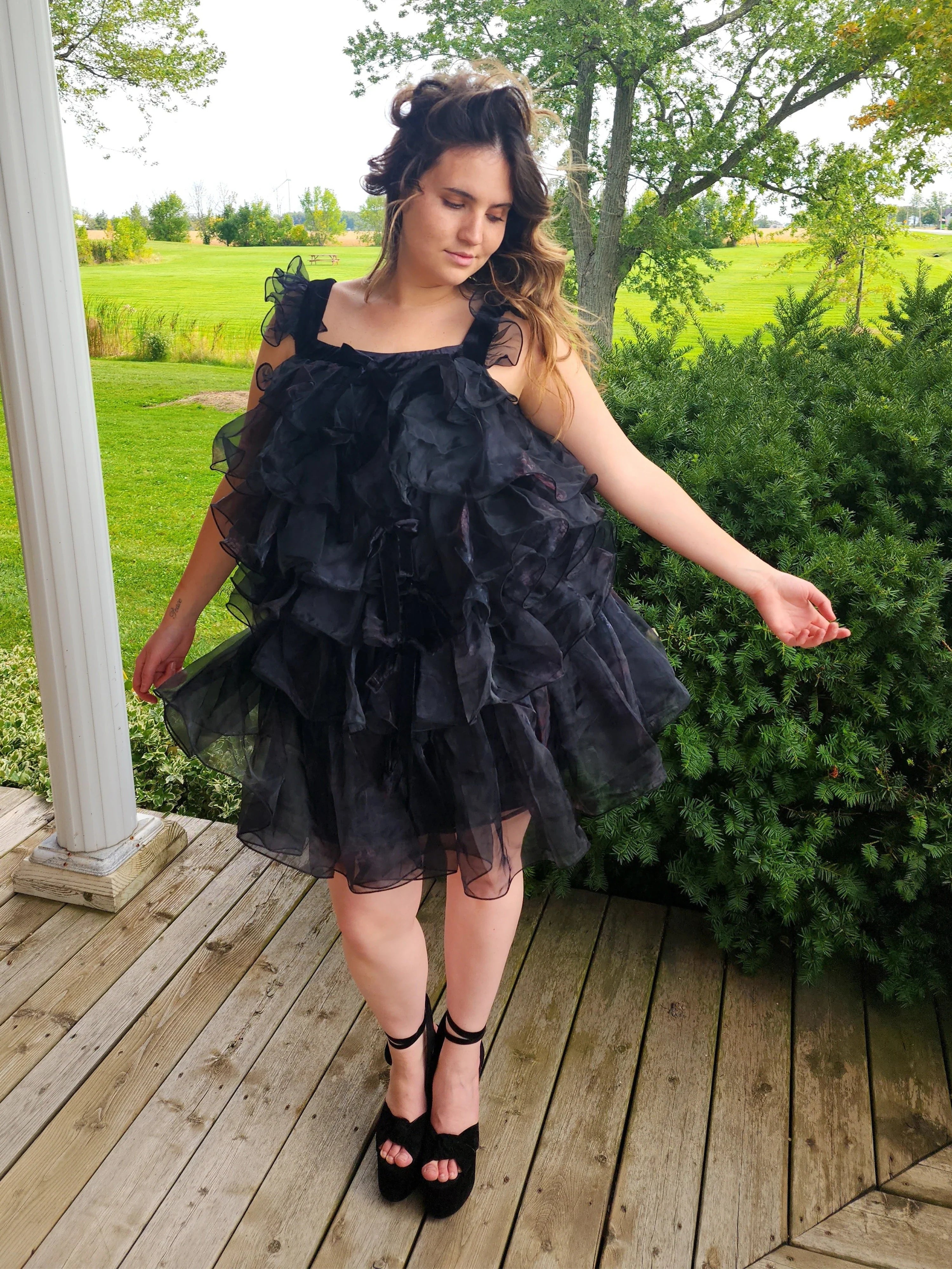 Ruffled off-shoulder black feather mini dress with tiered layers for stylish elegance