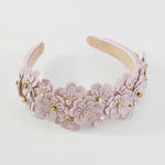 Lilac floral headband with gold accents on a white background.