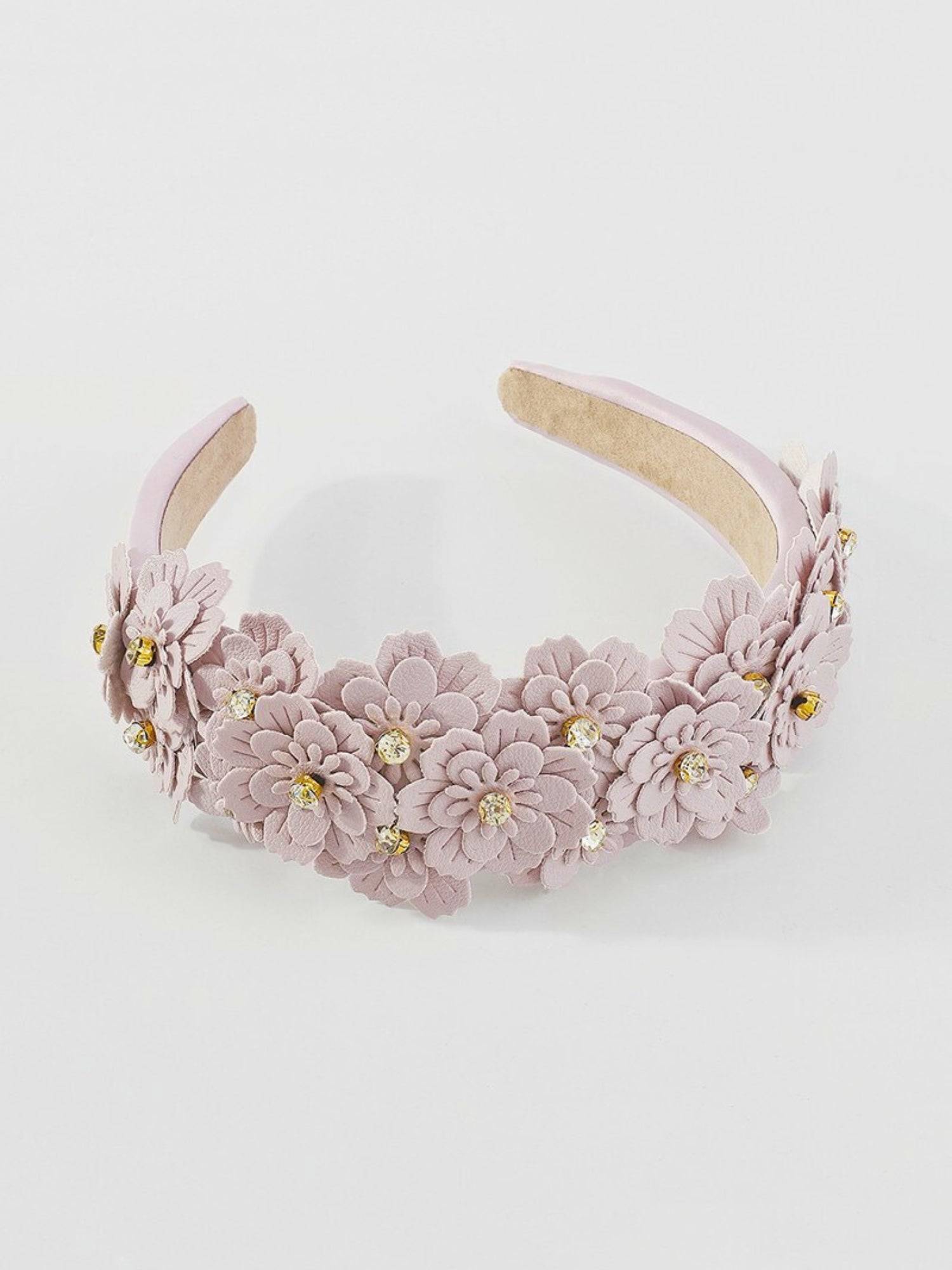 Lilac floral headband with gold accents on a white background.