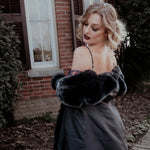 Back view of a woman in the Stained Rose Lilith Coat standing in front of a brick building.