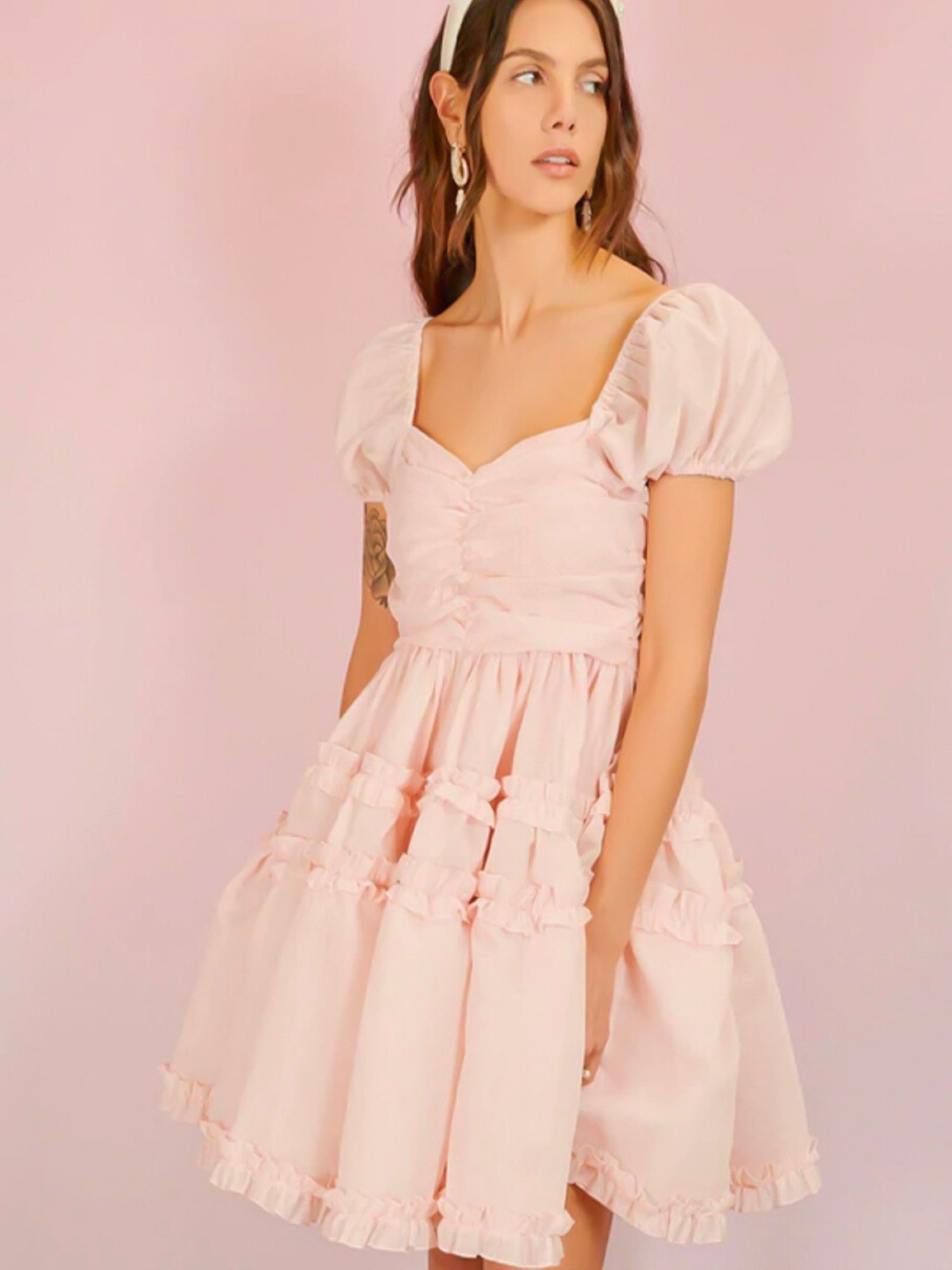 Pale pink Lillia Ruffle Mini Dress featuring frilly puff sleeves and gathered bodice