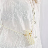 Delicate white blouse with embroidery and pearl purse, cutest accessory for lipstick holder