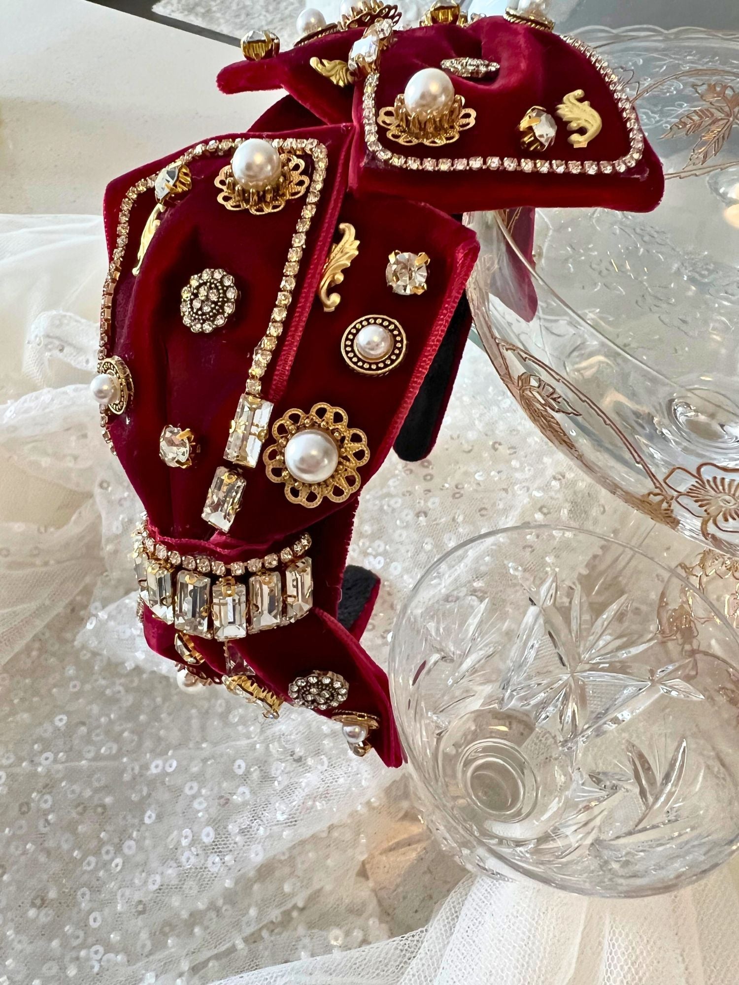 Ornate red velvet Blair Headband boasts exquisite details with pearls and metallic embellishments