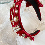 Ornate red velvet Blair Headband boasts exquisite details with pearls and gold embellishments