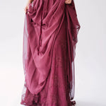 Detail view of The Scarlet Red Scorned Lovers Gown showing the layered chiffon skirt lifted to reveal floral lace beneath.