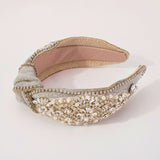 Ornate Luxe Headband with pearl and crystal embellishments on cream fabric