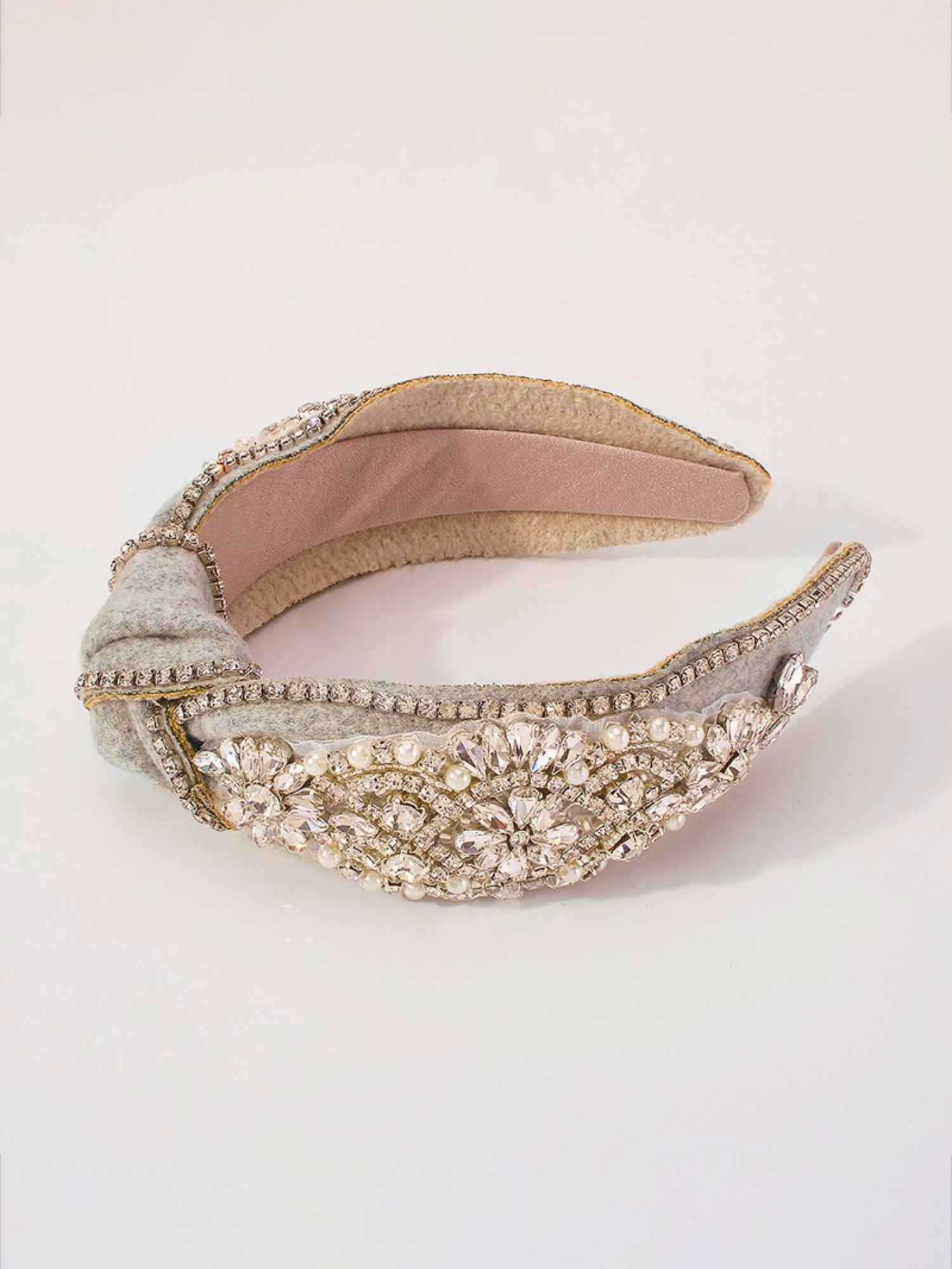 Ornate Luxe Headband with pearl and crystal embellishments on cream fabric