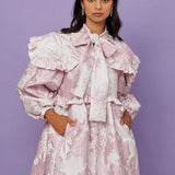 Frilly pale pink Misty Jacquard Bow Dress with puffed sleeves and bow collar