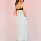 Woman in Ocean Blues Cami Midi Dress with floral print skirt and black top, back view