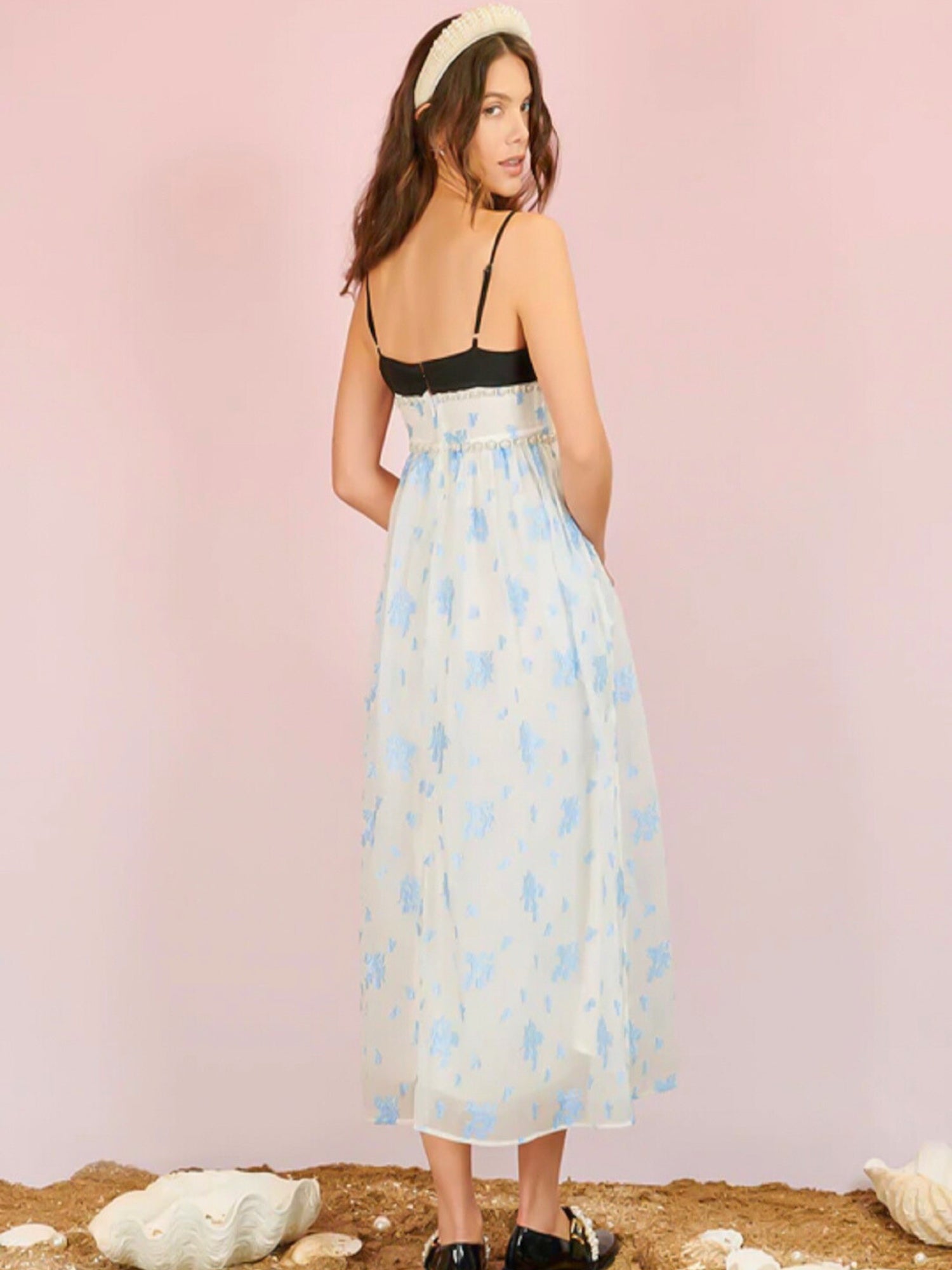 Woman in Ocean Blues Cami Midi Dress with floral print skirt and black top, back view