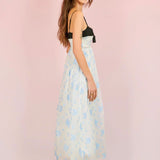 Woman in Ocean Blues Cami Midi Dress featuring a light blue floral design