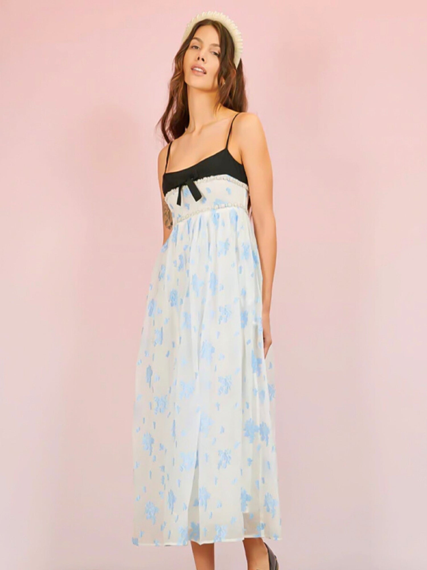 Woman in Ocean Blues Cami Midi Dress featuring a black bodice and blue patterned skirt