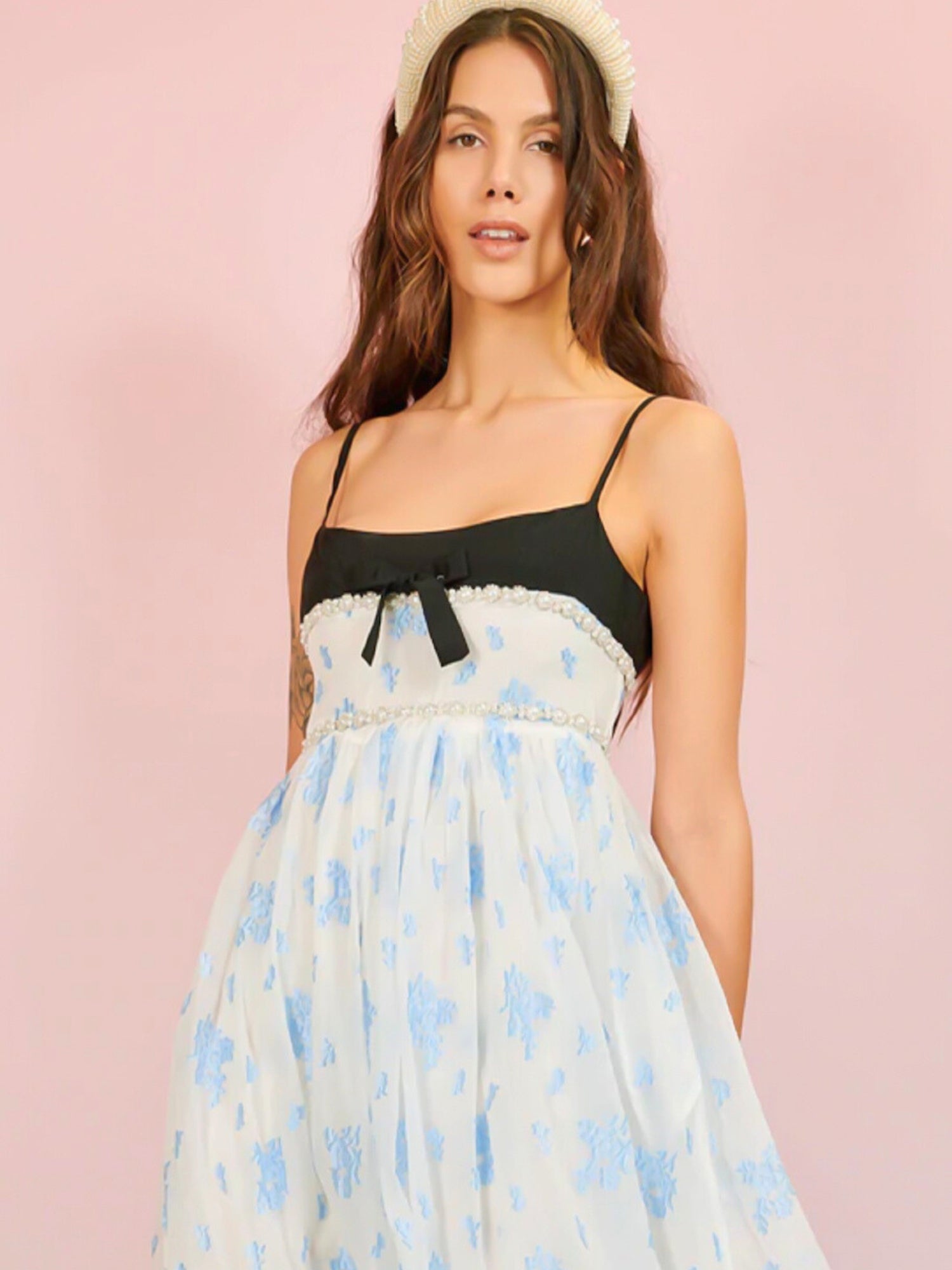 Woman in Ocean Blues Cami Midi Dress with floral design and black bow detail