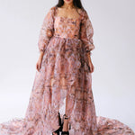 The ode to jove twilight reverie ball gown with puff sleeves, a train, and platform sandals.