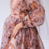 Ball Gown in soft peach and brown tones with sheer, billowing sleeves.