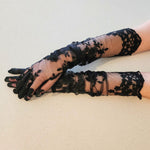 Hand sewn opera gloves featuring delicate black lace with a floral forearm pattern