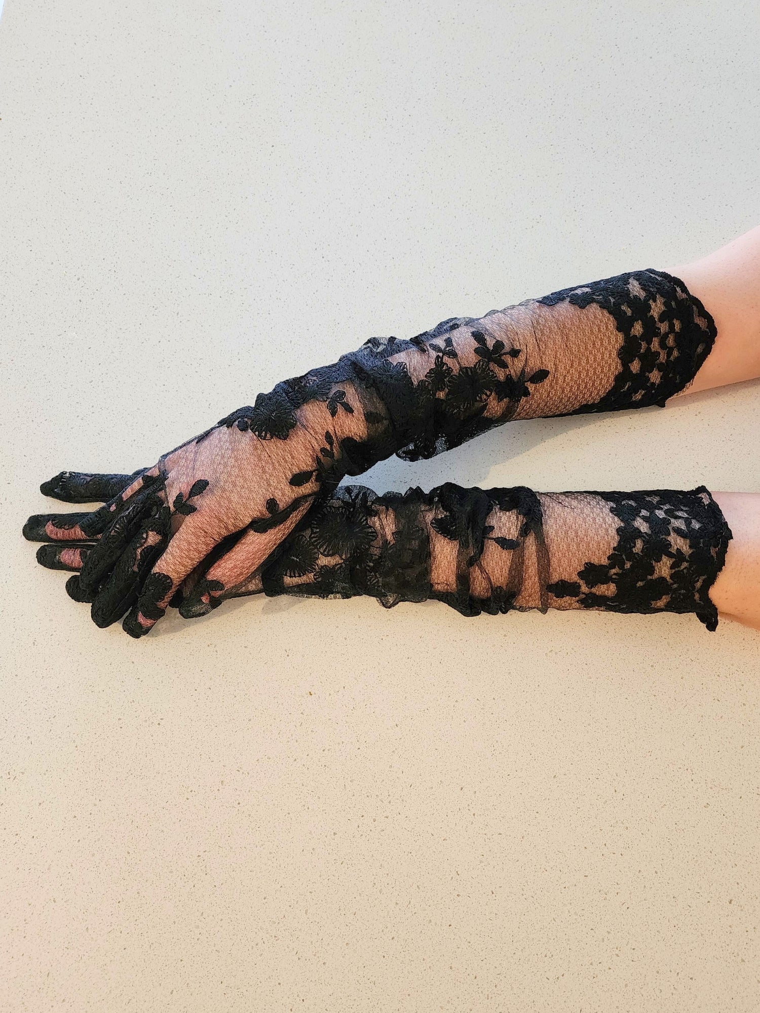 Hand sewn opera gloves featuring delicate black lace with a floral forearm pattern