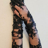 Hand sewn black lace opera gloves with delicate floral pattern for elegant style