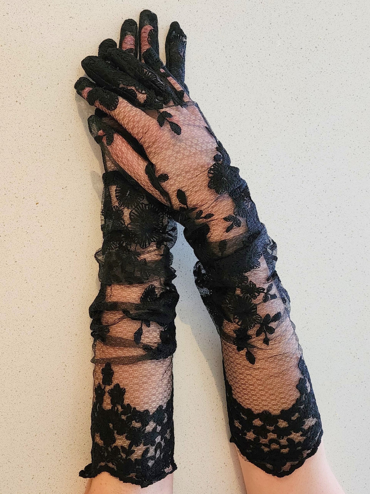 Hand sewn black lace opera gloves with delicate floral pattern for elegant style