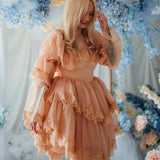 Smiling model in the Midnight Symphony Organza Mini Dress surrounded by pastel florals, capturing the dress’s whimsical and fairy tale essence.