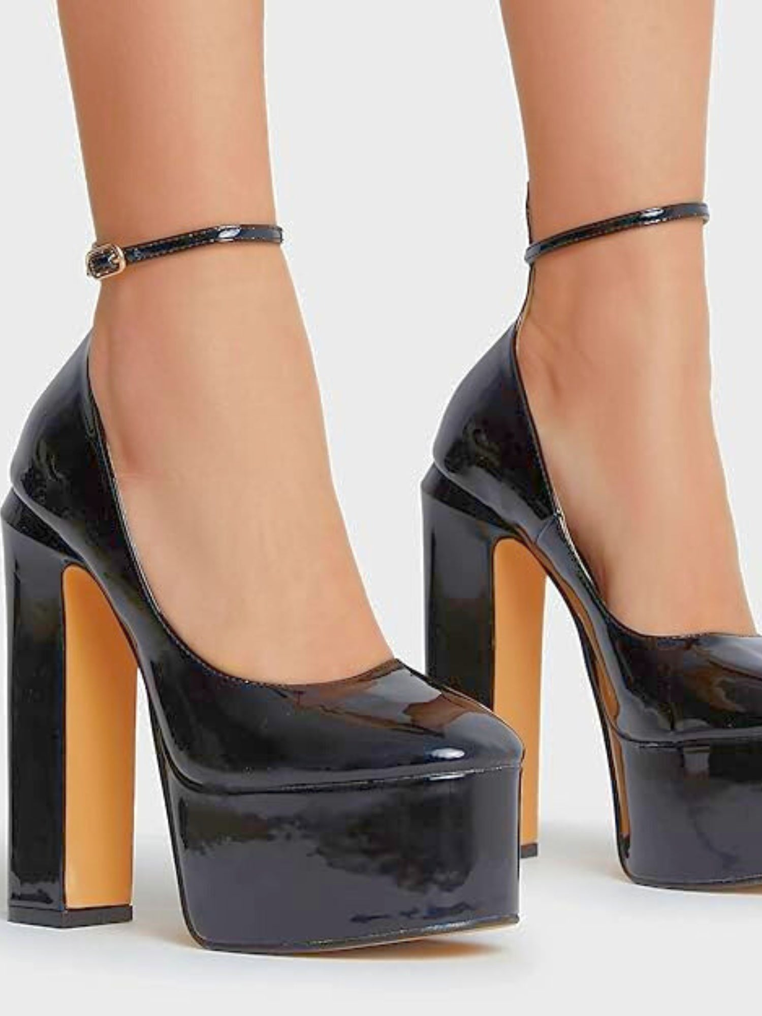 Glossy black platforms with thick ankle straps, perfect for a gown with a grand bow sash