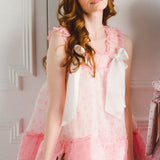 Woman in pink and white ruffled dress from the Parfait Poet Peignoir in Selkie Collection