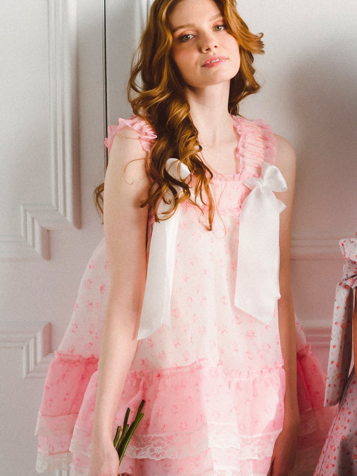 Woman in pink and white ruffled dress from the Parfait Poet Peignoir in Selkie Collection