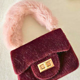 Burgundy velvet Petit Agneau micro handbag with fluffy pink faux fur handle and gold clasp