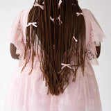 Long dark braids with white bows paired with the Pink Candy Cherub Dress in lace