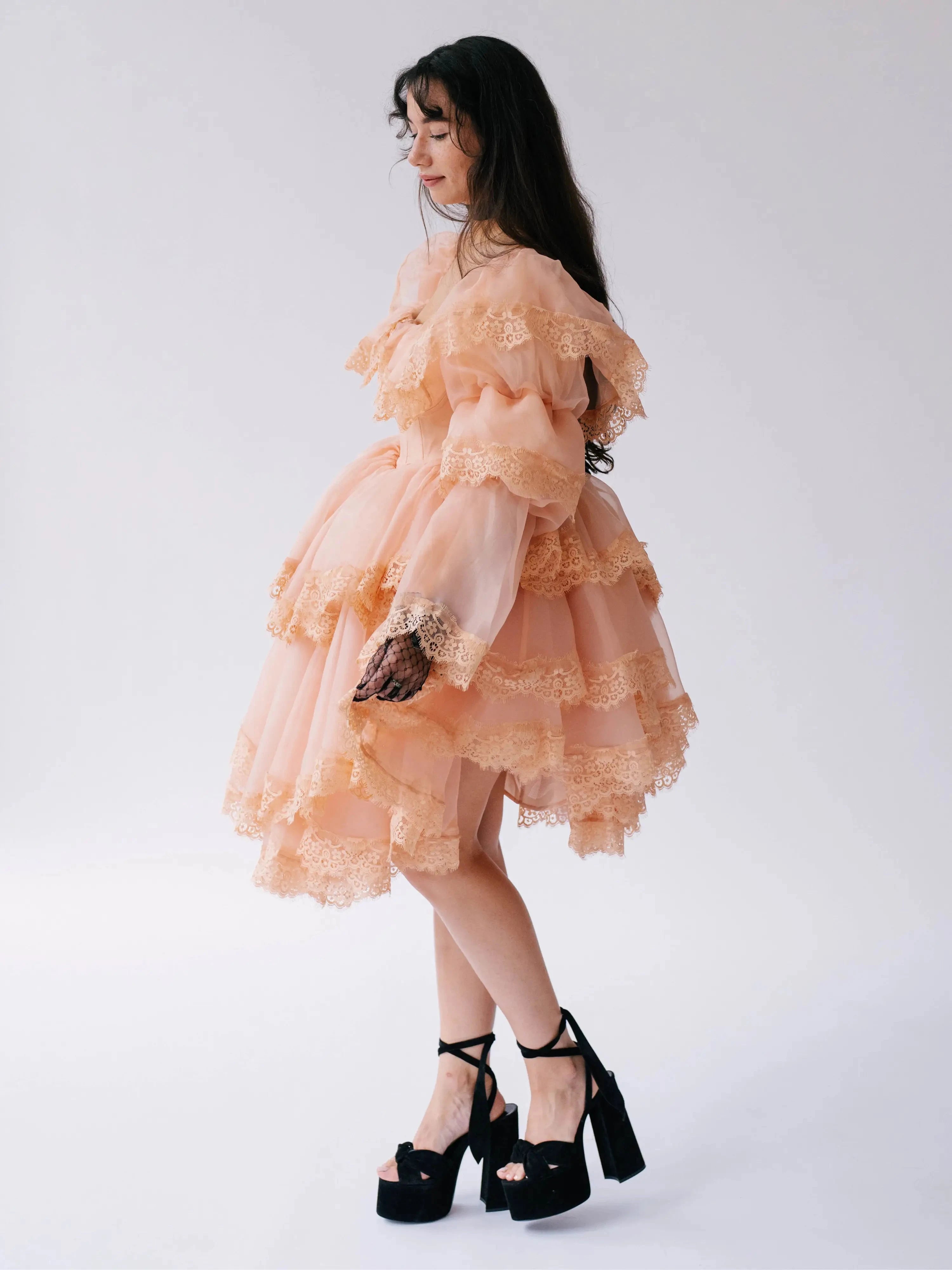 Side profile of the Midnight Symphony Organza Mini Dress with voluminous sleeves and flared skirt, perfect for statement looks in special events.