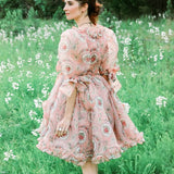 Floral pink Rapunzel Organza Marie Dress featuring a full skirt and long sleeves