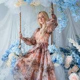 The Ode to Jove Twilight Reverie Ball Gown with baroque fresco print, worn on a floral swing surrounded by blue hydrangeas and white drapery.