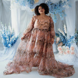 Plus-size model in the Ode to Jove Twilight Reverie Ball Gown with dramatic train and floral print, styled in a garden-inspired setting.