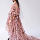 Side profile a woman wearing the Ode to Jove Twilight Reverie Ball Gown with long sleeves and flowing silhouette, styled with a tiara and veil.