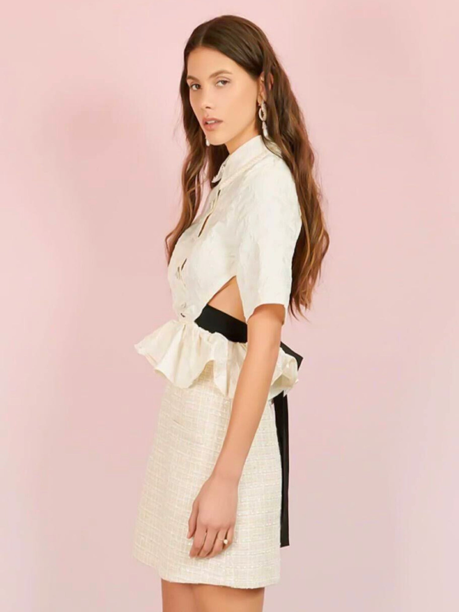 Woman in a white short-sleeved gown featuring a grand bow sash from Seashore Cropped