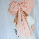 Back view of the Baby Antoinette Pink Hair Bow showing its 25-inch length and structured silk taffeta design in soft pink.