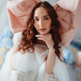 Baby Antoinette Silk Hair Bow styled with a white lace dress, featuring oversized silk taffeta design for coquette fashion lovers.
