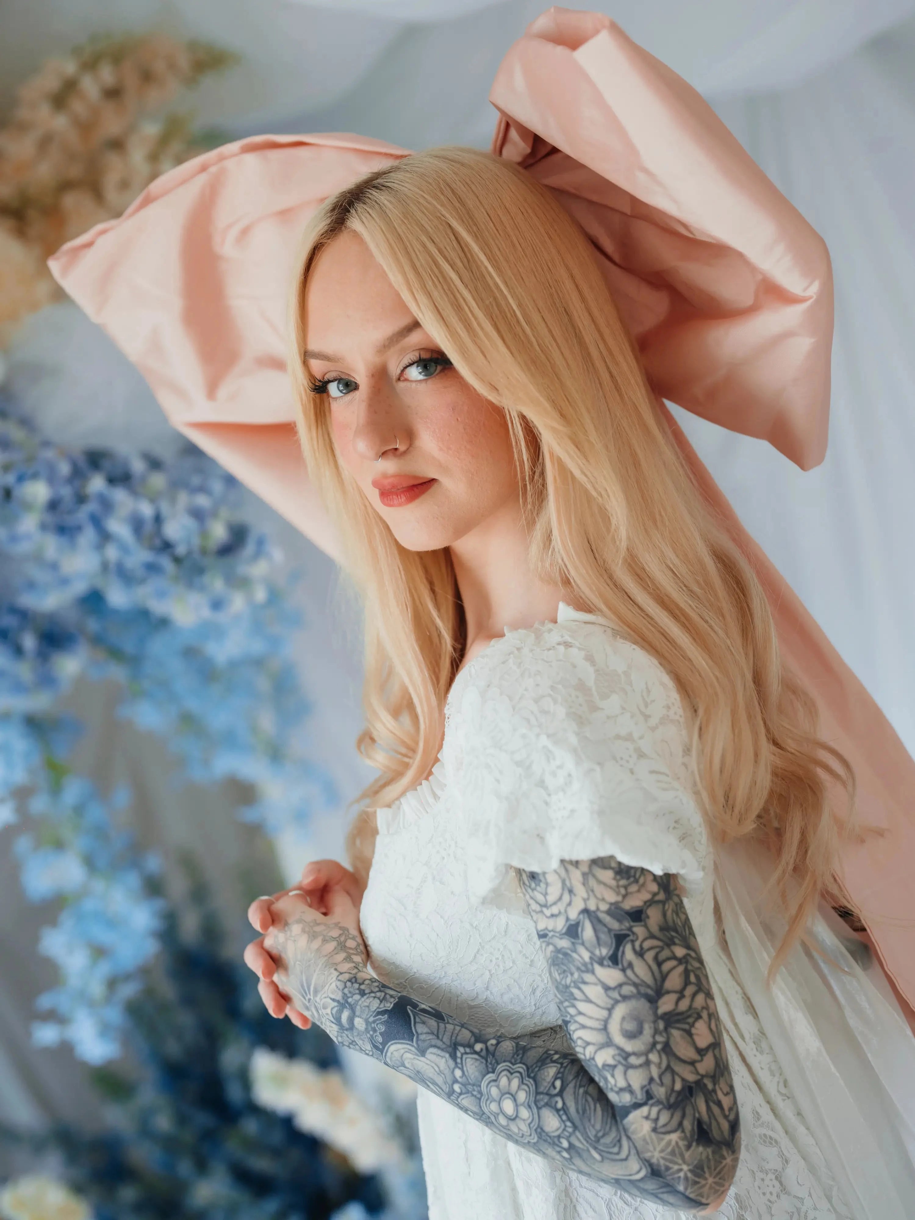 Side view of the Baby Antoinette Silk Hair Bow with flowing tails, styled with long blonde hair and a lace dress for a romantic finish.