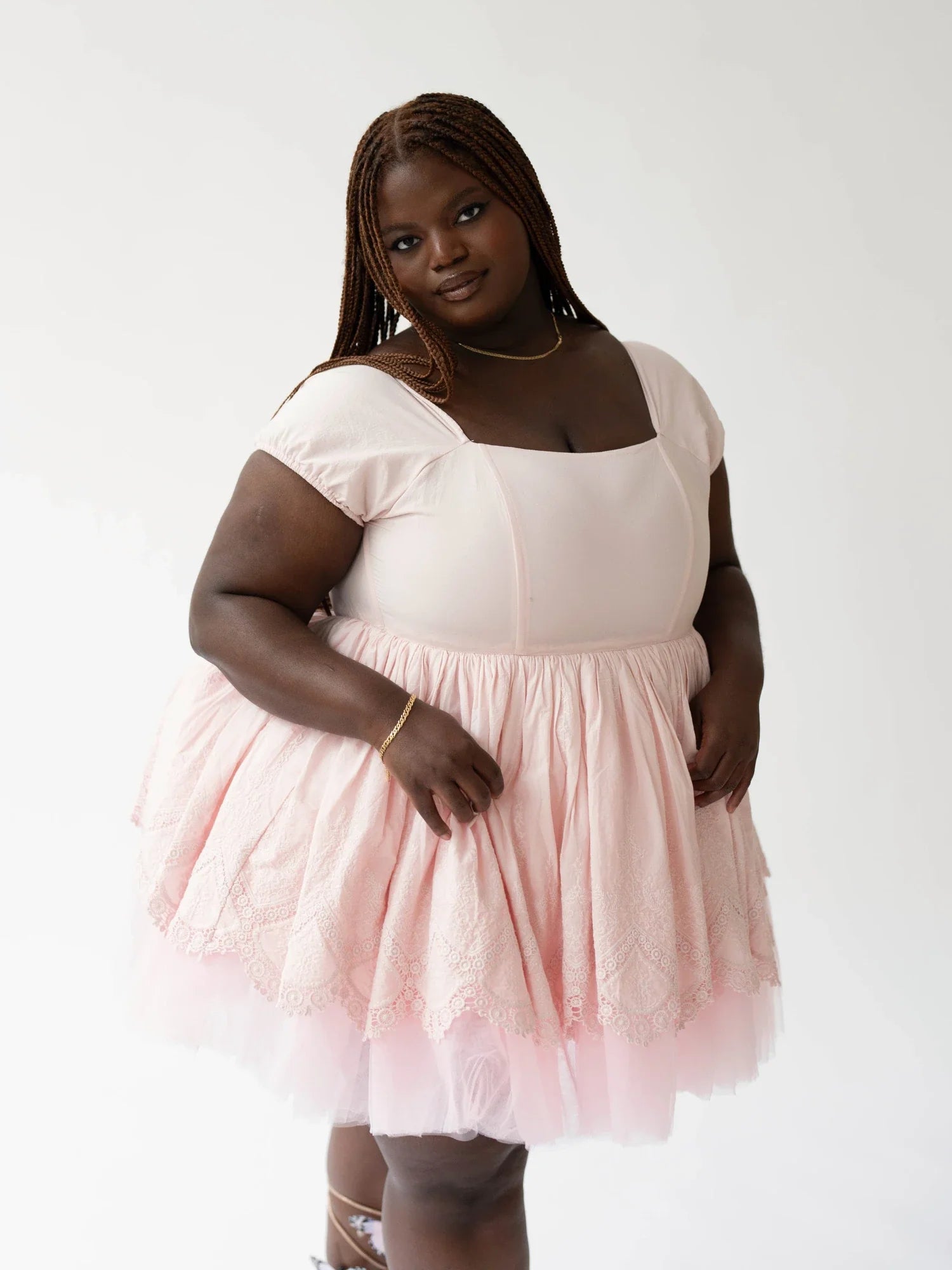 Woman in a Soft Pink Blossom Dress featuring a white bodice and tulle skirt