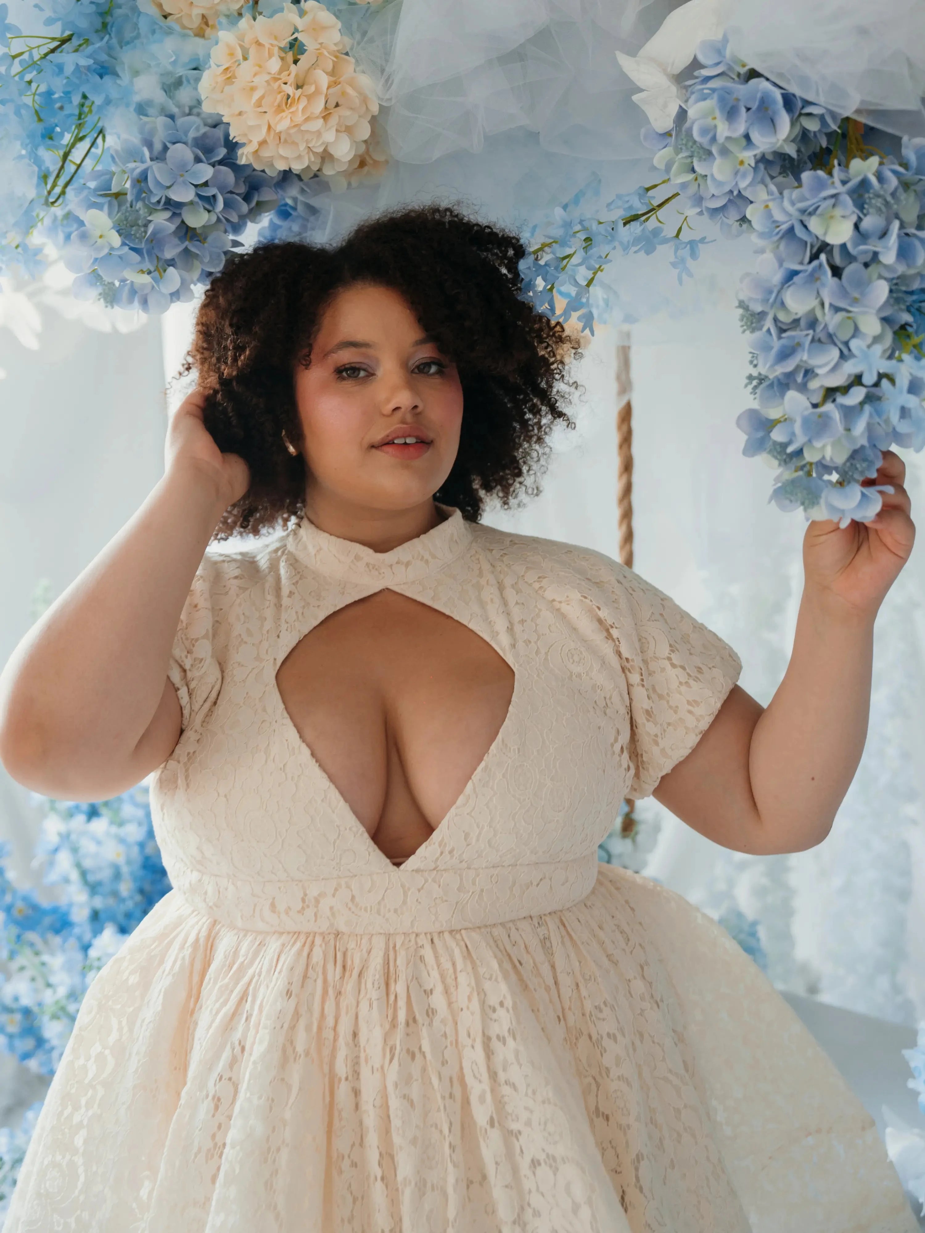 Close-up of plus-size model in The Victorian Lace Tea Party Mini Dress with diamond keyhole bust and floral lace texture.