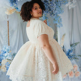 Back view of plus-size model twirling in The Victorian Lace Tea Party Mini Dress, highlighting lace detail and full skirt.
