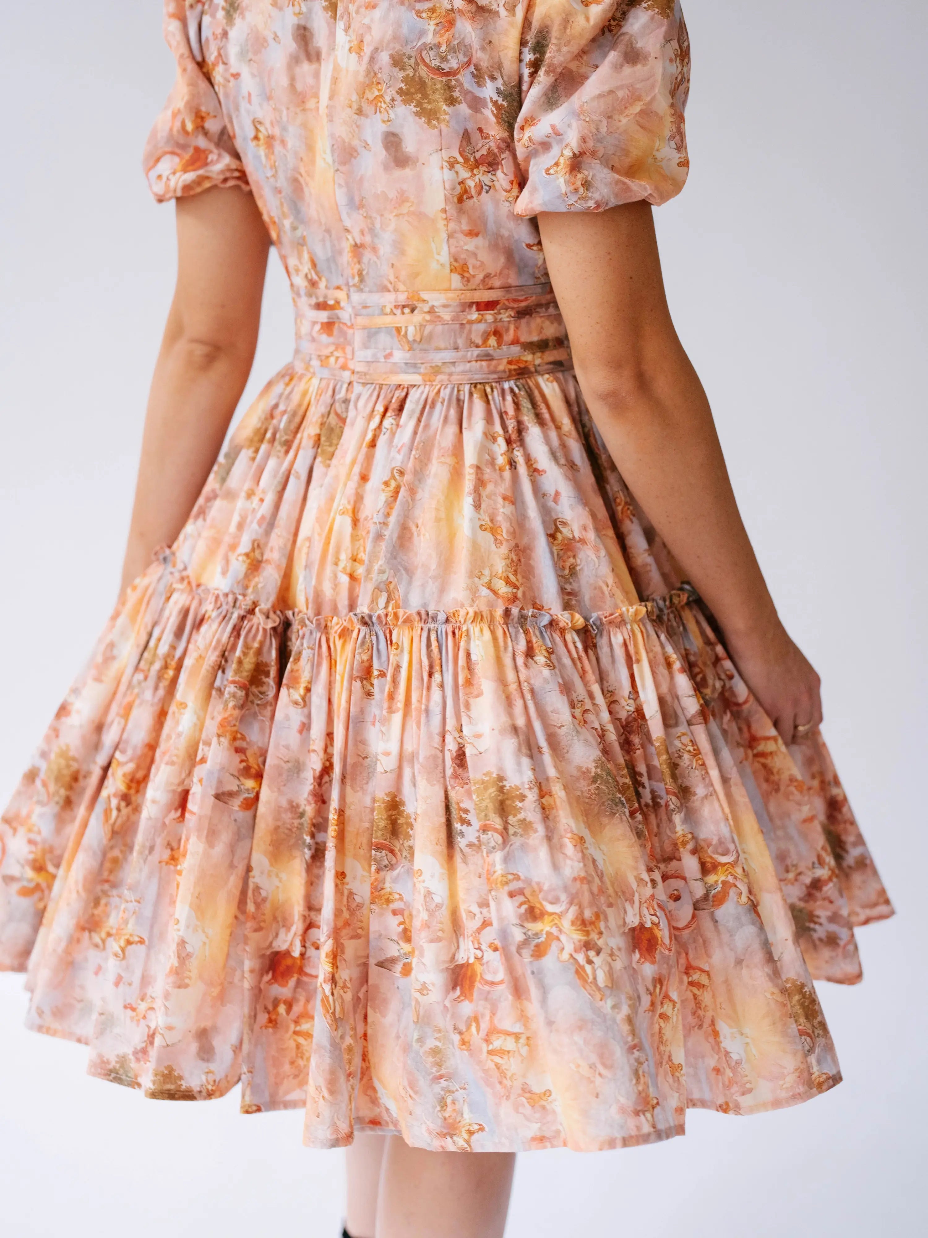 Midi day dress with puff sleeves and a tiered, gathered skirt.