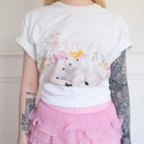 Front view of The Little Lamb Tee tucked into a pink layered lace skirt, featuring charming lambs and floral artwork for a dreamy look.