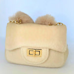 Ivory The Petit Agneau Tiny Purse with gold chain strap and faux fur texture, combining elegance and compact design in a micro handbag.