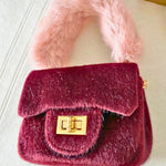 Micro-sized The Petit Agneau Tiny Purse in wine with soft faux fur handle and gold hardware, ideal for stylish minimal accessories.