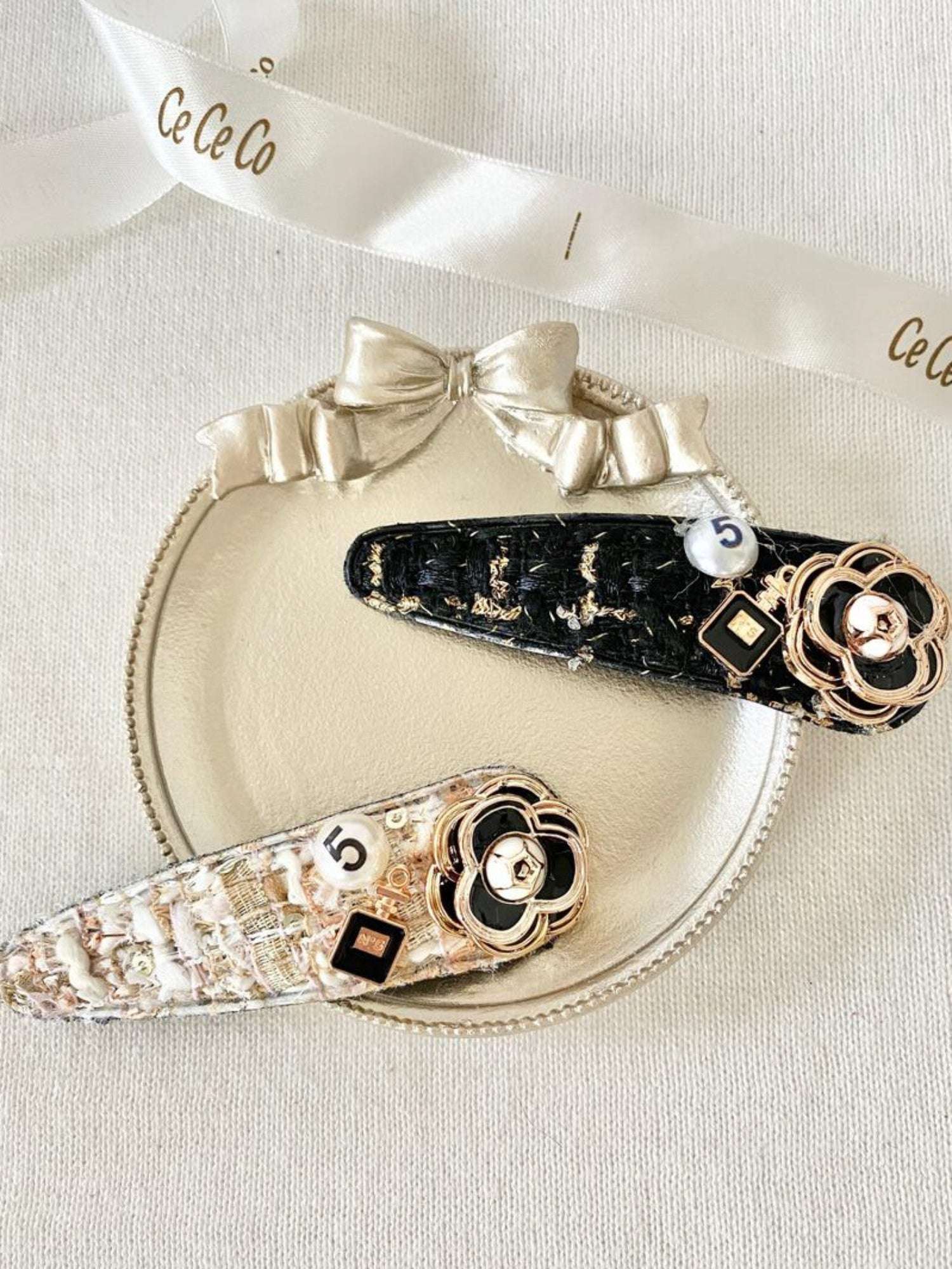 Two decorative peony hair clips featuring floral designs and rhinestone accents.