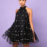 Black halter neck mini dress with white floral patterns and tulle skirt for twirling