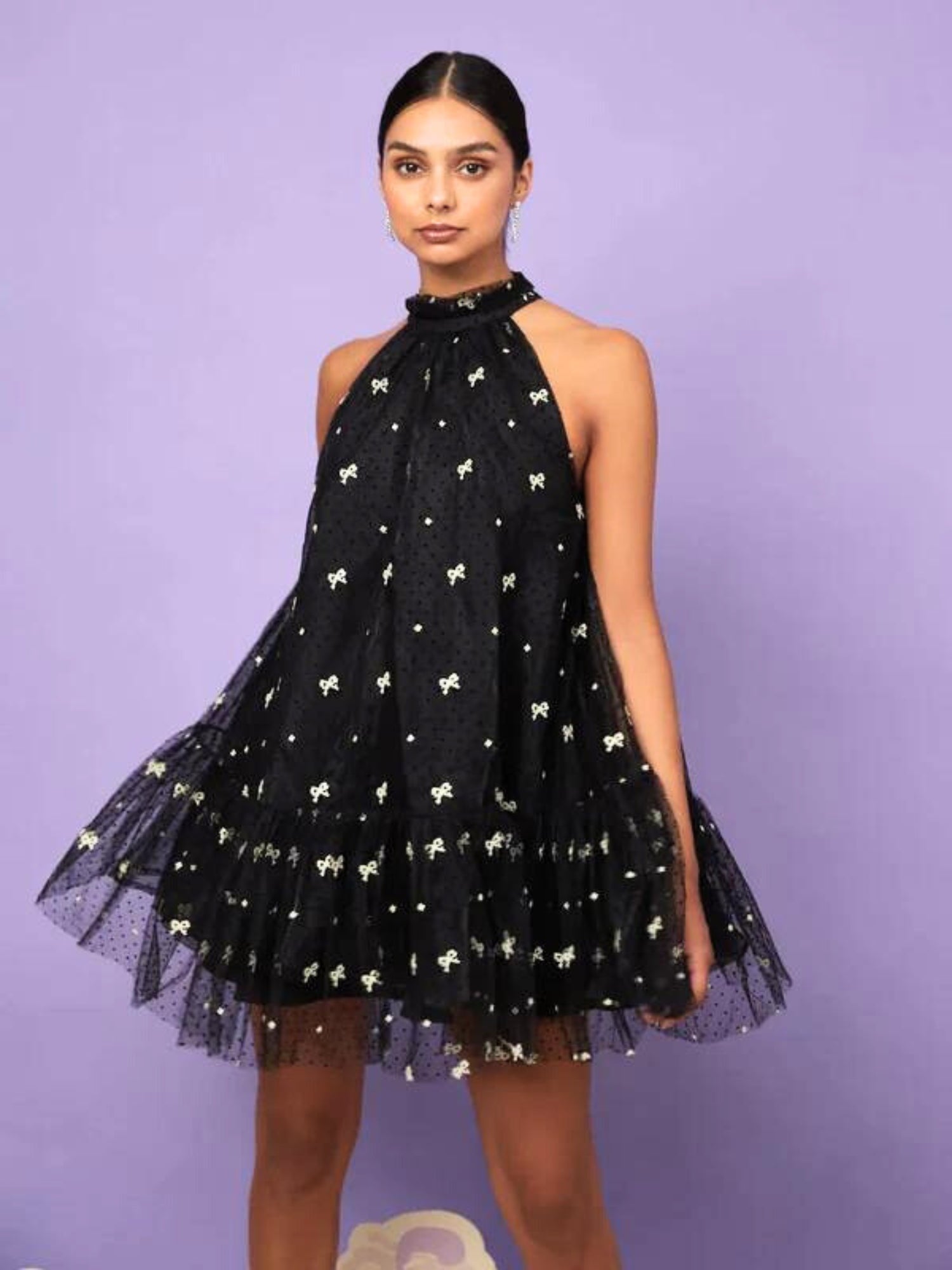 Black halter neck mini dress with white floral patterns and tulle skirt for twirling