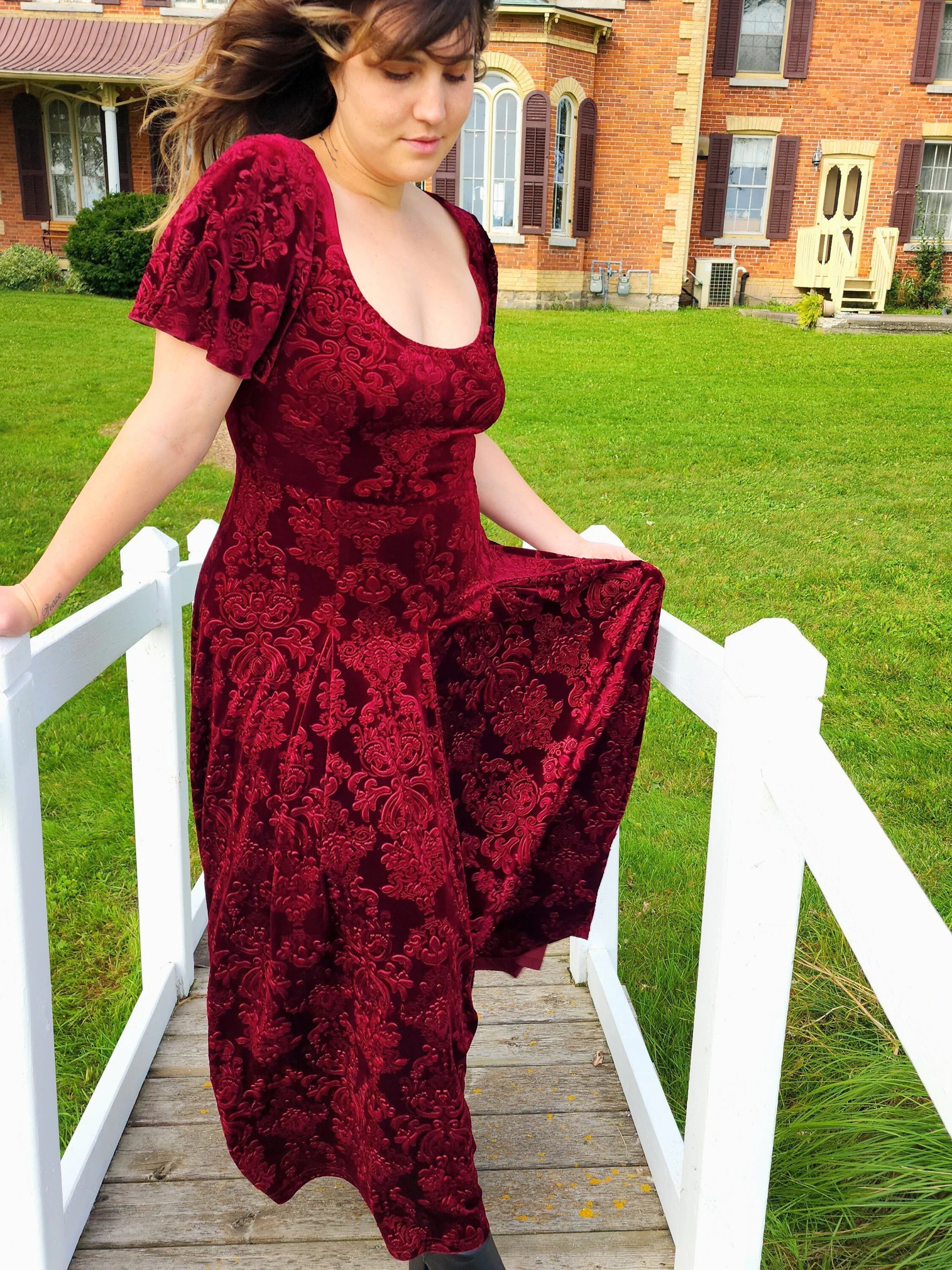 Burgundy Velvet Viola Dress featuring short sleeves and a flowing skirt